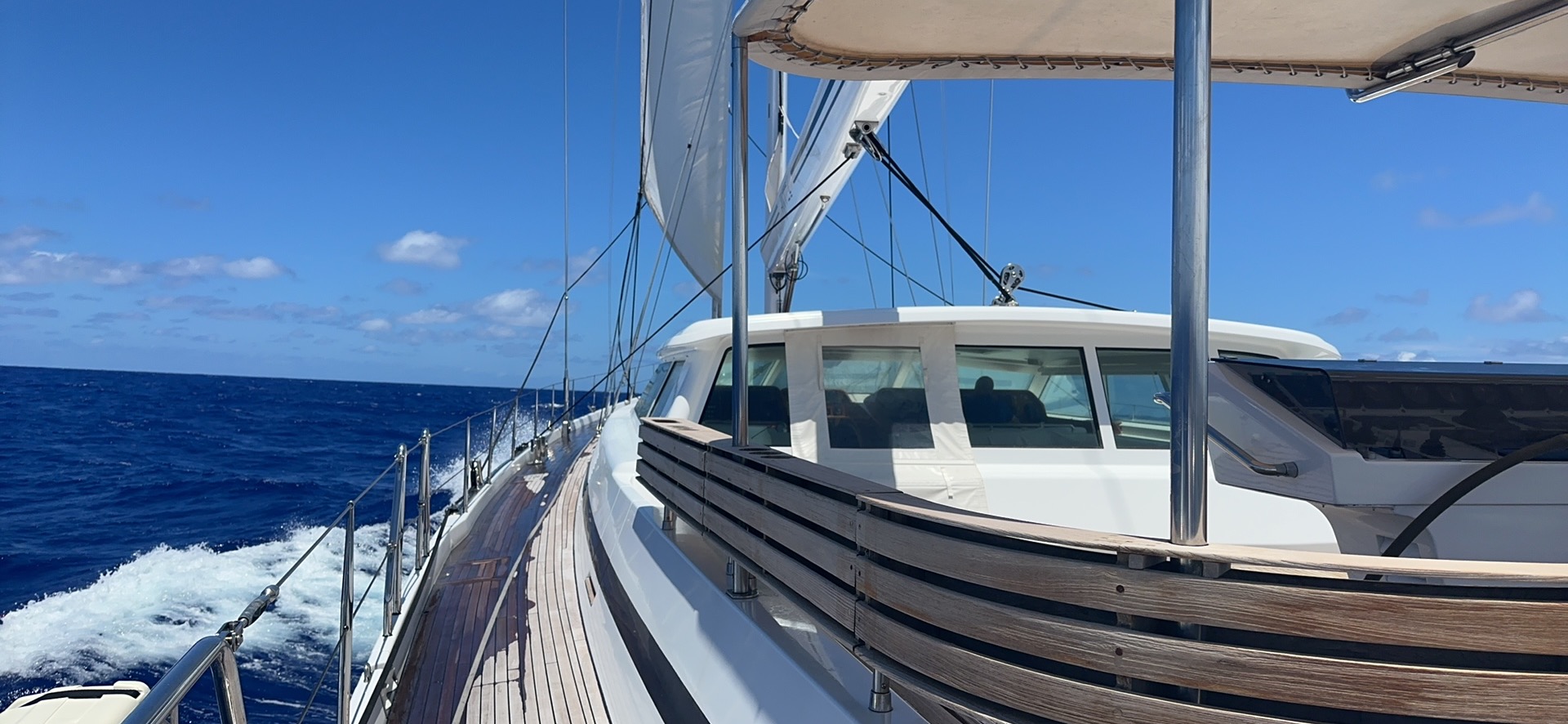 Professional yacht captain commanding a sailing yacht during an offshore ocean passage.