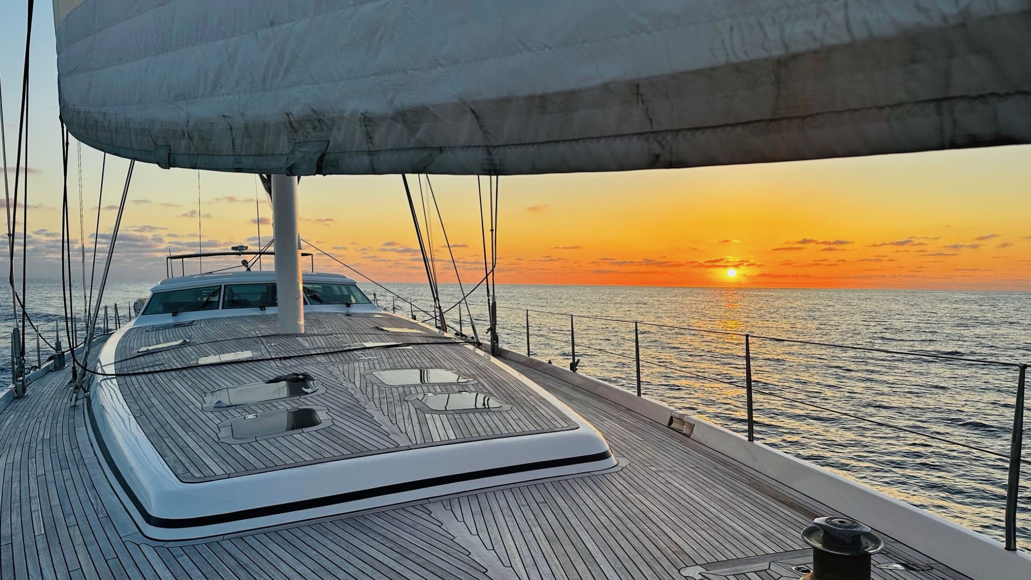 Atlantic Ocean yacht delivery during sunrise aboard a sailing yacht.