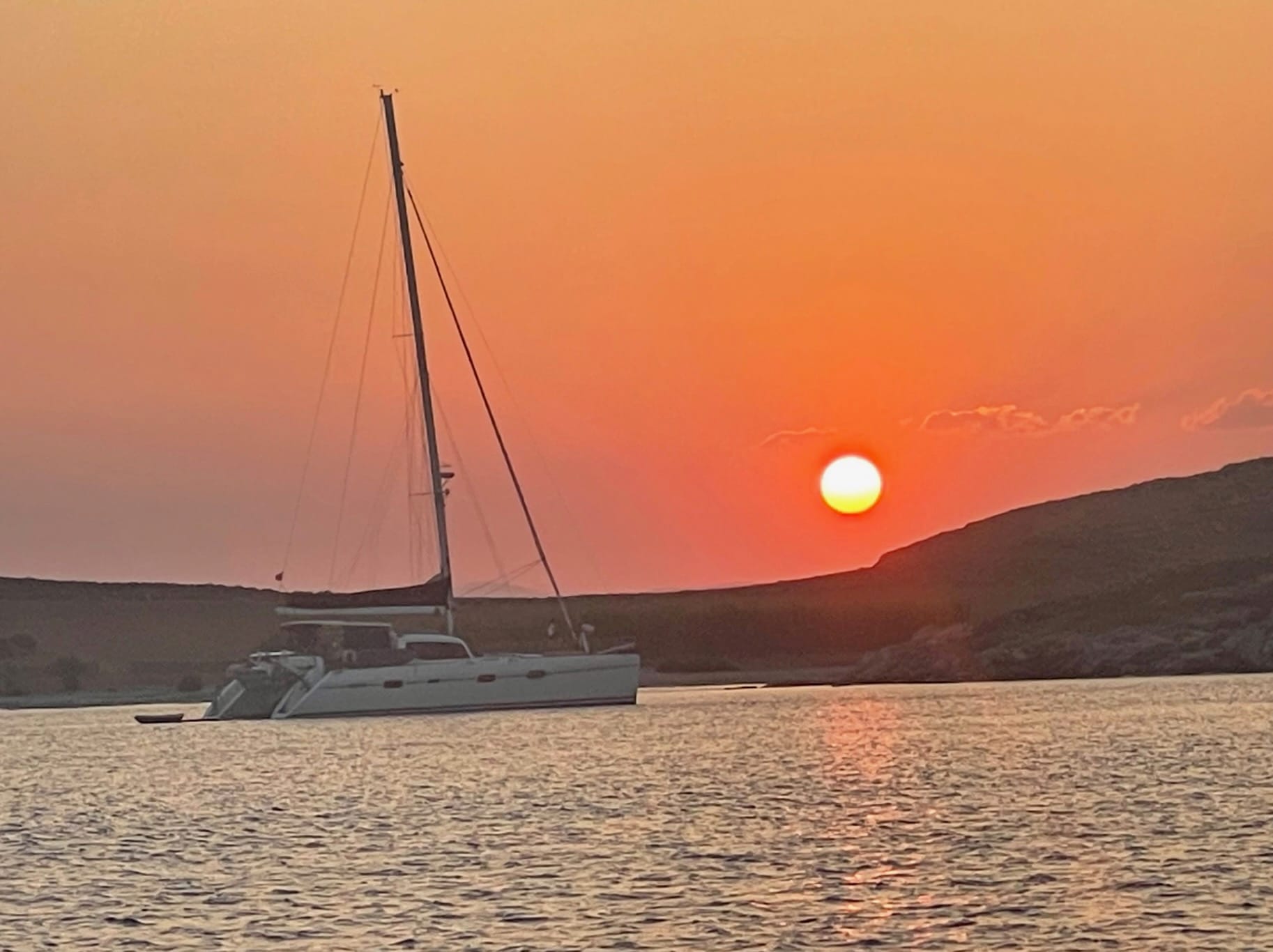 Sailing yacht at sunset during a Mediterranean sailing passage
